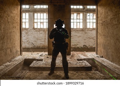 Silhouette of a special forces operator in abandoned building during his cqb tactical training.