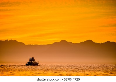 Silhouette Of Speed Boat In The Ocean At Sunset. Boating At Sunset In Atlantic Ocean, South Africa