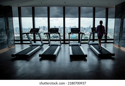 Silhouette sport fitness woman wearing sportwear with workout  under exercise on treadmill machine gym is sport healthy body building in fitness lifestyle.