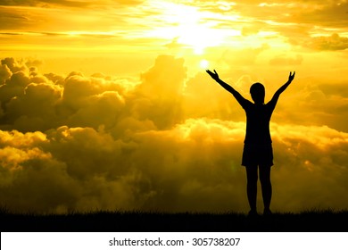 Silhouette of sport women open arms raised towards on hope sky at sunset light effect ,Concept for life achievements and success