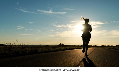 silhouette sports girl running along road sunset, american woman running along road, urban marathon runner crossing finish line, confident motivated beautiful sportswoman, athletic woman running on - Powered by Shutterstock