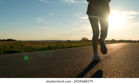silhouette sports girl running along road sunset, legs close-up, sprint endurance exercise, jogging road, running fast intense workout, sunset health, triathlon exercise, treadmill sunset, goal