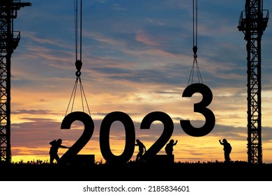 Silhouette of staff works as a team to prepare to welcome the new year 2023 - Shutterstock ID 2185834601