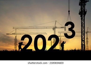 Silhouette of staff works as a team to prepare to welcome the new year 2023 - Shutterstock ID 2185834603