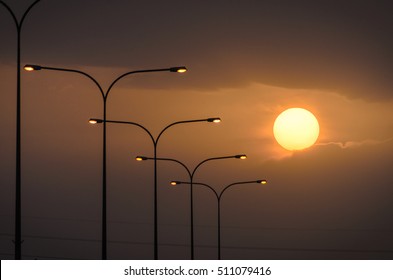 Silhouette of street lights during beautiful sunset - Powered by Shutterstock