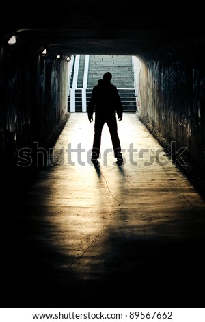 silhouette in a subway tunnel