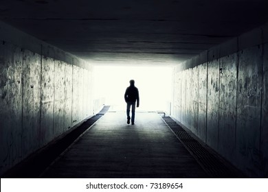 silhouette in a subway tunnel. Light at End of Tunnel