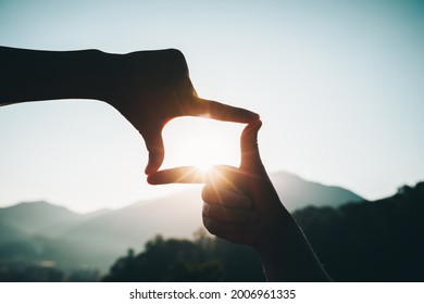 Silhouette Of Successful Woman Hands Making A Frame On Sunrise Mountain Top