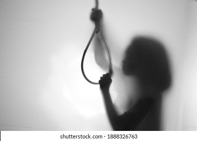 Silhouette of suicider going to hang himself.