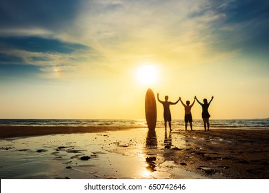 Silhouette of surf man happy friend group stand with surfboard, open arms. Surfing at sunset beach. Outdoor water sport adventure lifestyle.Summer activity.  - Powered by Shutterstock