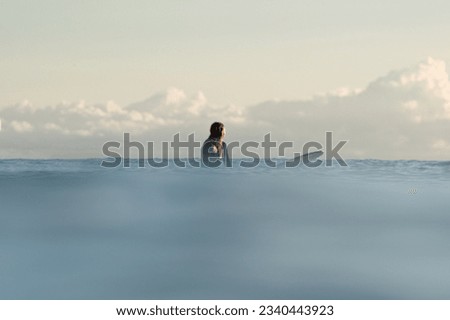 Silhouette of a surfer floating in the ocean
