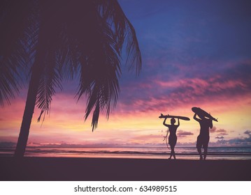 Silhouette Of Surfer People Carrying Their Surfboards On Sunset Beach, Vintage Filter Effect