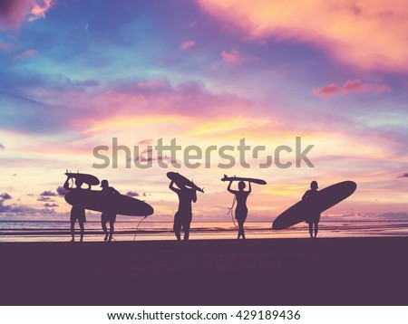 Similar – Image, Stock Photo Surfers on the beach go to the sea