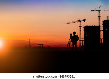 Silhouette Of Survey Engineer And Construction Team Working At Site Over Blurred  Industry Background With Light Fair For Industrial Businesses, Global Contract Work