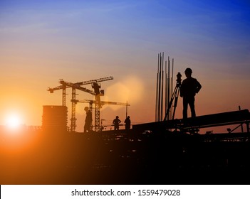 Silhouette of Survey Engineer and construction team working at site over blurred  industry background with Light fair Film Grain effect.Create from multiple reference images together - Shutterstock ID 1559479028
