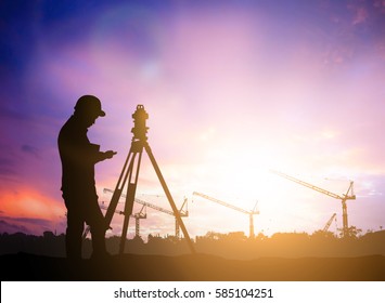 Silhouette Survey Engineer Working  In A Building Site Over Blurred Construction Worker On  Industrial Site