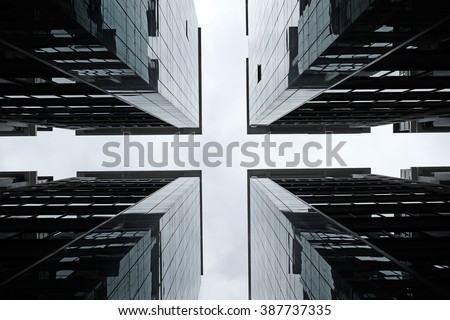 Silhouette of symmetrical glass towers on a cross road.
