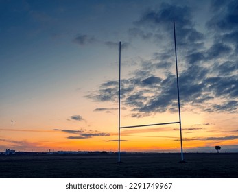 Silhouette of a tall goal post for Irish National sports comogie, hurling, rugby and gaelic football against blue and orange sun rise sky. - Powered by Shutterstock