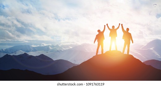 Silhouette of the team on the mountain. Leadership Concept - Shutterstock ID 1091763119