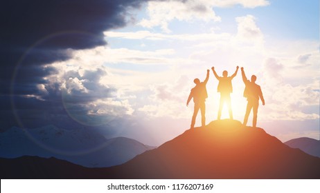 Silhouette of the team on the mountain. Leadership Concept - Shutterstock ID 1176207169