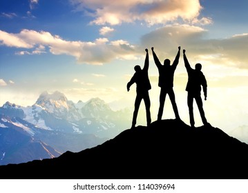 Silhouette of team on the mountain top. Sport and active life