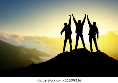 Silhouette of the team on the peak of mountain. Sport and active life - Shutterstock ID 113099116