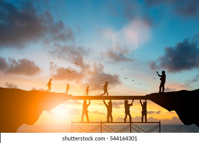 Silhouette  team responsible helped build the foundation for a child to grow up and grow efficiently over blurred natural. - Shutterstock ID 544164301