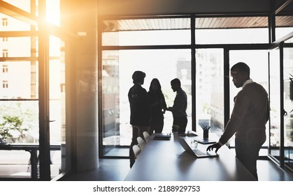 Silhouette of team waiting for presentation in boardroom with leader getting work ready to start. Group of people standing, discussing and talking in the background before the meeting begins. - Shutterstock ID 2188929753