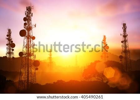 silhouette of Telecommunication mast television antennas on sunset and flare light