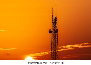 Silhouette Of Telecommunication Tower With Cellular Network Antennas During Sunset