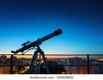 Silhouette of a telescope aimed at the stars of the galaxy on the background of the night city. Image on the topic of research, education, etc. 