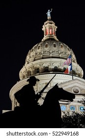 A Silhouette Of Terry's Texas Rangers Monument Framed By The Texas Capitol Dome At Night In Downtown Austin.