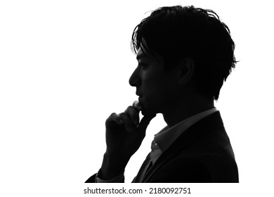 Silhouette of thinking asian businessman.