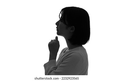 Silhouette of thinking Asian woman profile.