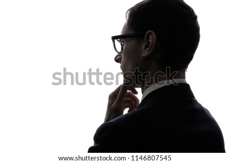 Silhouette of a thinking businessman.