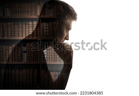 Silhouette of a thinking man on the library hall background with books in bookcases. Concept on education, science, literature, business, thinking, psychology, memory, philosophy, history.