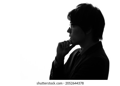 Silhouette of thinking young asian businessman.