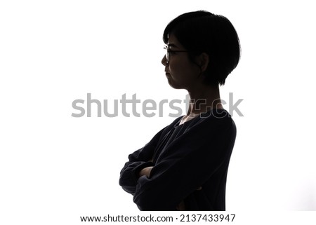 Silhouette of thinking young asian woman.