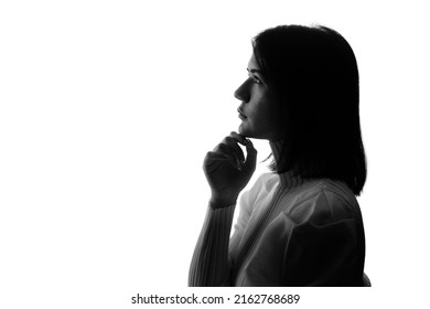 Silhouette of thinking young half Latina and half Asian woman.