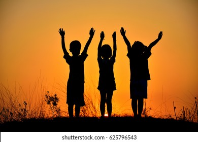 Silhouette of three children friendship at sunset.People friendship silhouette. - Powered by Shutterstock