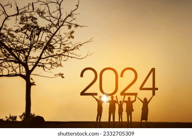 Silhouette of three generations family holding 2024 new year numbers while standing near a tree at the park - Powered by Shutterstock