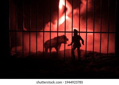 Silhouette Of A Tiger Miniature Standing In A Zoo Cage With Scared Man Ready To Attack. Creative Decoration With Colorful Backlight With Fog. Selective Focus