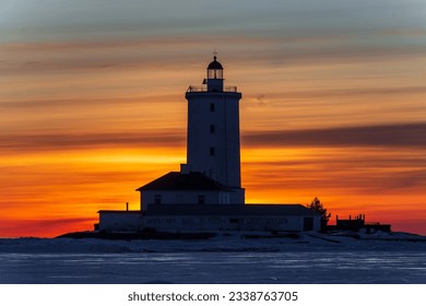 Silhouette of Tolbukhin lighthouse, winter evening, Kronstadt, Gulf of Finland, Russia 

Translation of the text: 
