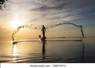 Silhouette of traditional fishermen throwing net fishing at sunrise time, livelihoods of fishermen at Pakpra, Phatthalung in Thailand - Shutterstock ID 758579572