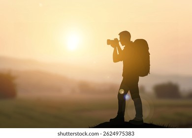 Silhouette of a travel photographer with a backpack, taking a photo in the early morning light. The glowing sun in the background and scenic landscape reflect themes of exploration copy space for text
