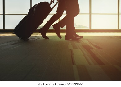 Silhouette Traveler With Luggage Walking In The Airport