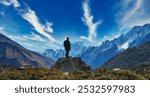 Silhouette of a trekker standing on a rock. The breathtaking moment captures the essence of achievement, challenge, and success, symbolizing the spirit of adventure in the heart of nature