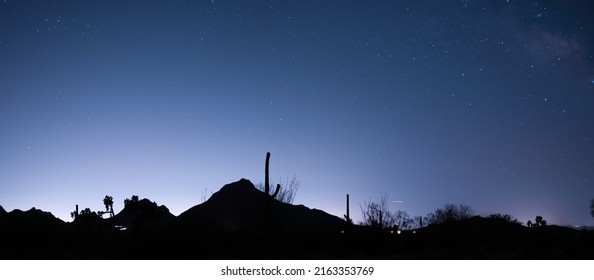 Silhouette Of Tucson Arizona Mountains At Night, Lights From Campers Under The Stars. 