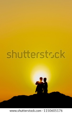 Two people watching the sunset