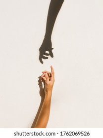 Silhouette of two hands are drawn to each other on a cream isolated background. - Shutterstock ID 1762069526